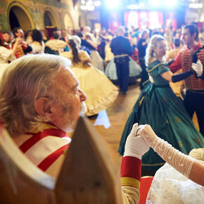 Formal ball scene: a romantic couple dominates a refined, elegant dance.