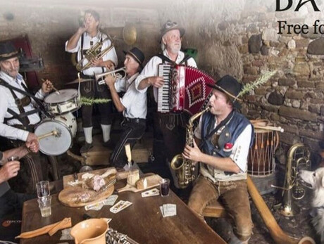 SIX MUSICIANS IN A CELLAR SINGING AND PLAYING WITH A DOG NEARBY