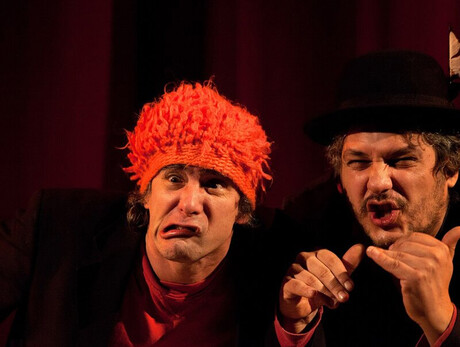 L'immagine mostra gli attori durante una scena dello spettacolo con due facce molto buffe