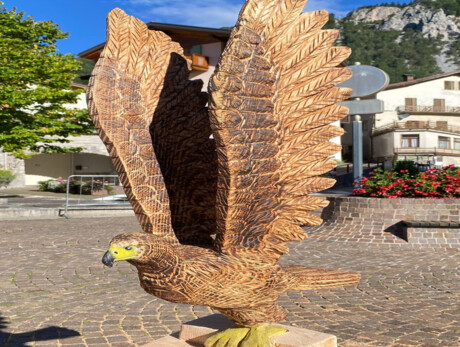a wooden eagle in the church square 