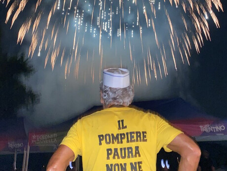 man with his back to the fireworks, on his shirt is the inscription ‘The fireman is not afraid’.