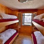  foto van Private 4-bed room with bedding