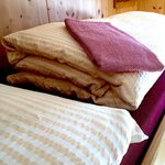  foto van Bed with bedding in shared room, with BB