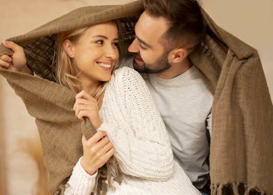 happy-couple-under-blanket