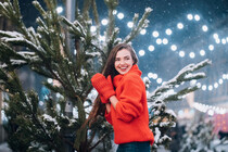 young-woman-posing-near-the-christmas-tree-on-the-