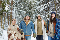 happy-young-friends-in-winter-forest